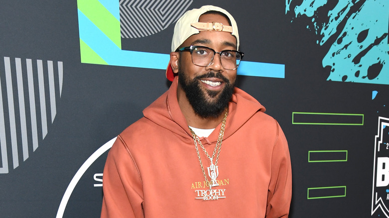 Marcus Jordan on a red carpet, smiling