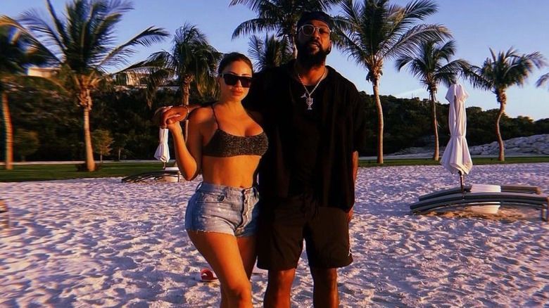 Larsa Pippen and Marcus Jordan pose on a beach