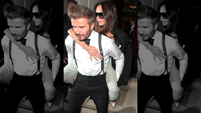 David Beckham carrying Victoria Beckham on his back