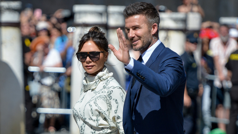 David Beckham waving with Victoria Beckham