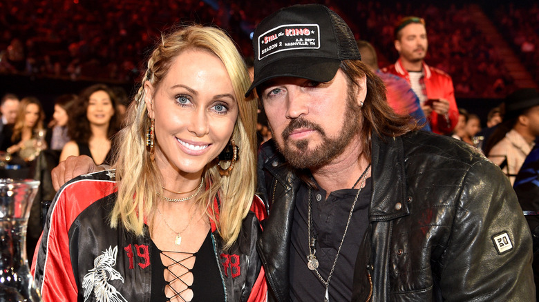 Tish and Billy Ray smiling at event