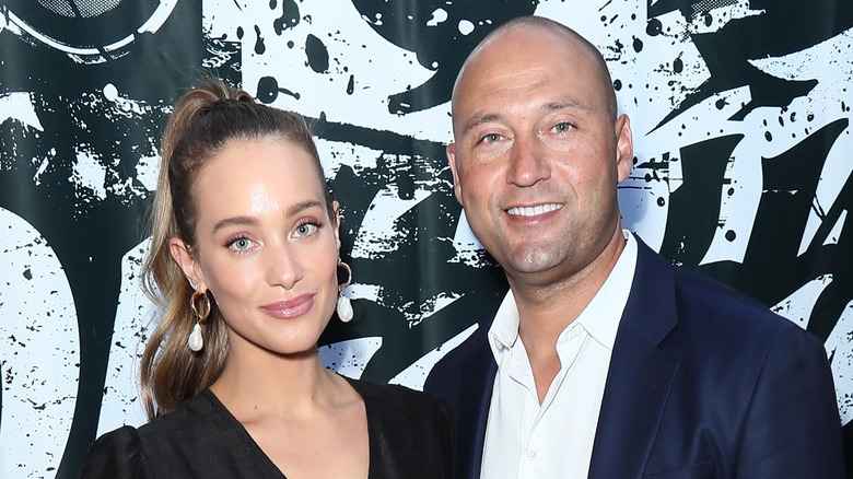 Derek and Hannah Jeter pose for photos in front of black-and-white backdrop.