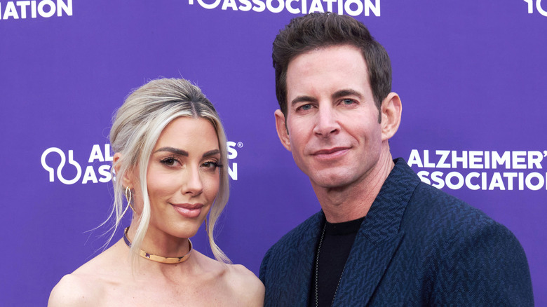 Heather Rae and Tarek El Moussa with purple backdrop