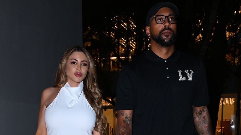 Larsa Pippen white dress Marcus Jordan black shirt