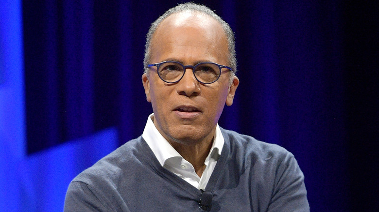 Lester Holt wearing a collared shirt and gray sweater