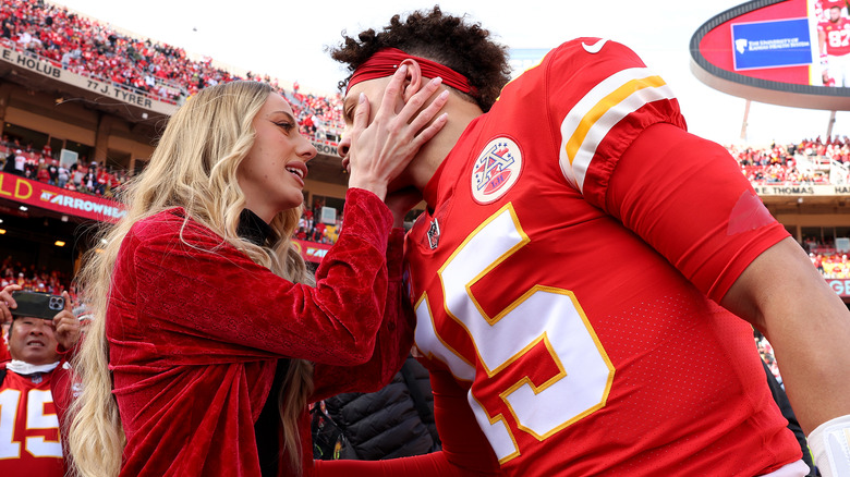 Brittany Mahomes placing hands on Patrick Mahomes' face