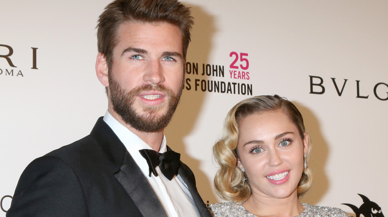 Liam Hemsworth posing with Miley Cyrus