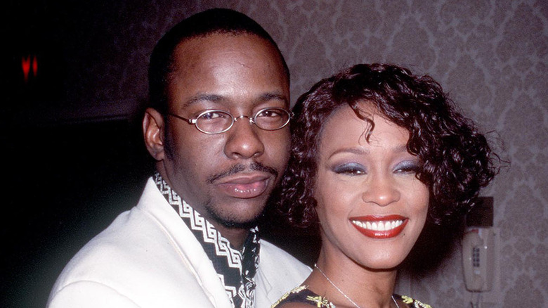 Bobby Brown posing with Whitney Houston