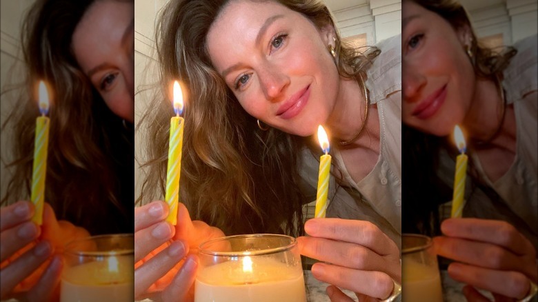 Gisele Bundchen holding candles
