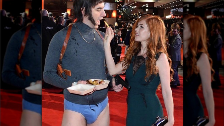 Isla Fisher feeding Sacha Baron Cohen