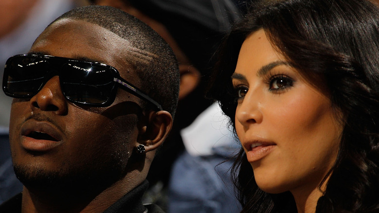 Reggie Bush and Kim Kardashian watching an event