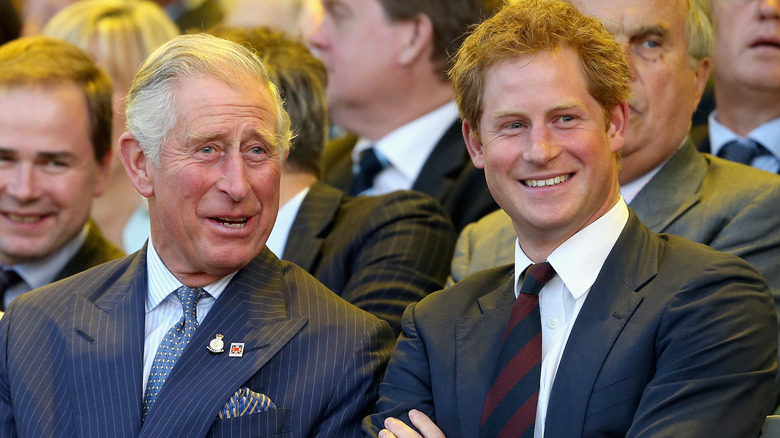 King Charles and Prince Harry smiling 