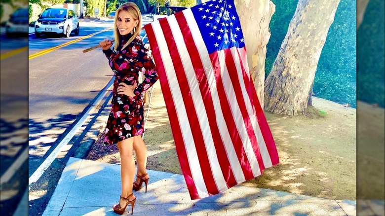 Cheryl Hines holding an American flag in 2020