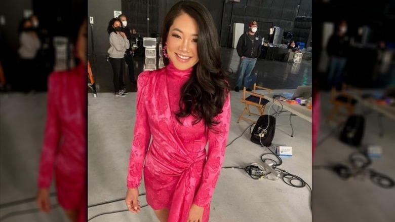 Crystal Kung Minkoff smiles wearing pink dress