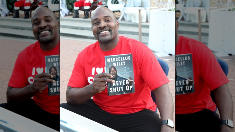 Marcellus Wiley posing with book