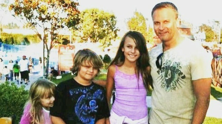 Simon Barney smiling and posing with his children, Spencer, Sidney, and Sophia