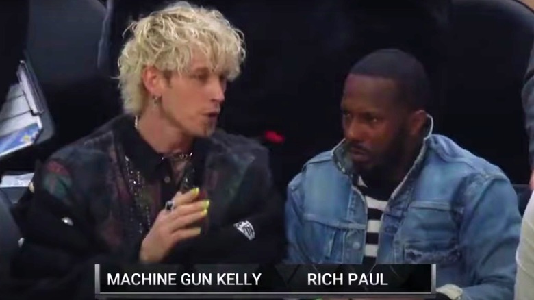 Machine Gun Kelly and Rich Paul talking courtside