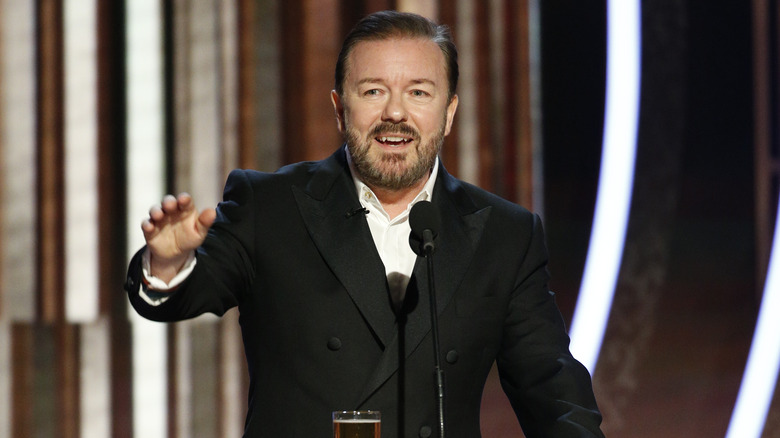 Ricky Gervais speaking on a podium