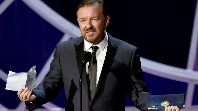 Ricky Gervais on stage with a microphone