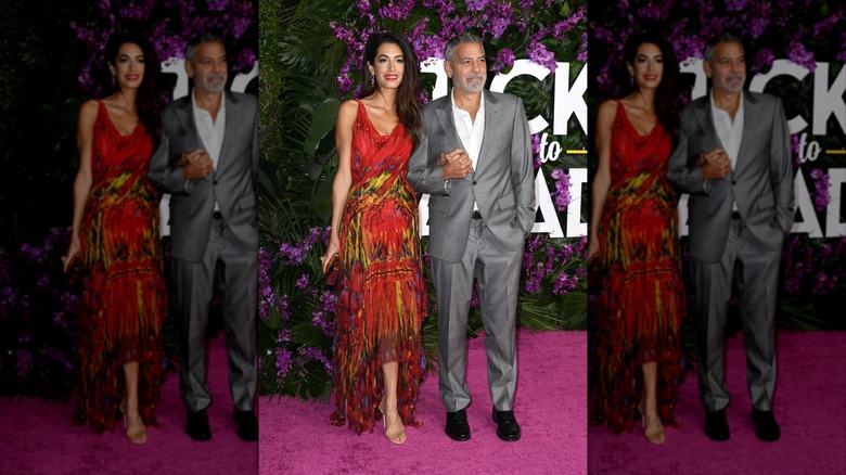 Amal and George Clooney posing at the 'Ticket to Paradise' L.A. premiere