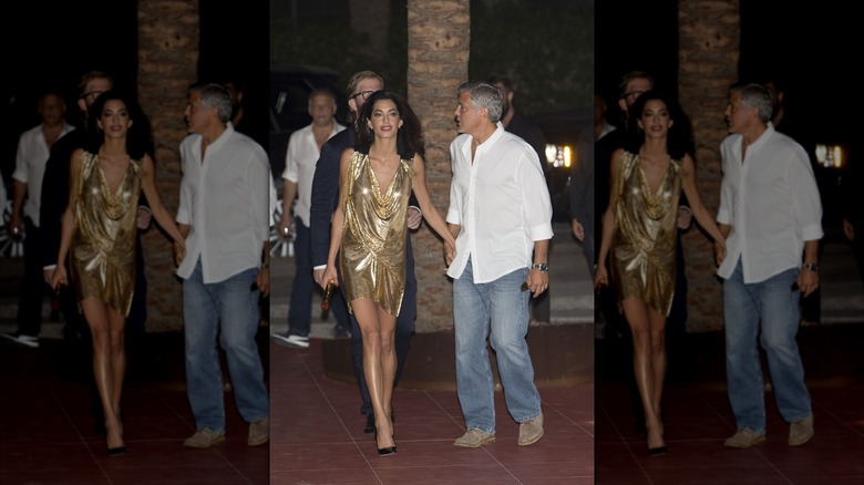 Amal Clooney in a gold dress; George Clooney in polo and jeans