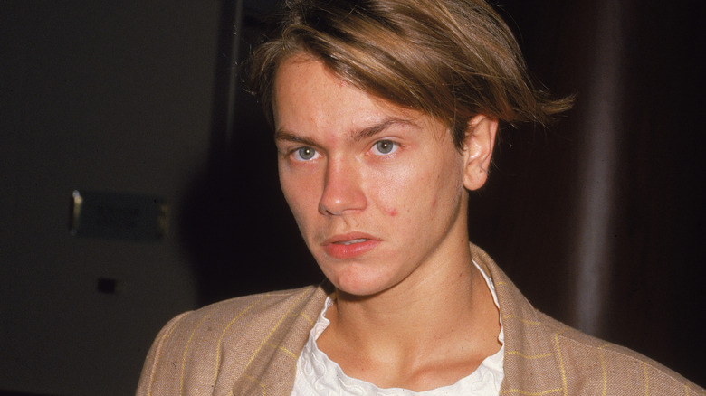 River Phoenix wearing a tan blazer