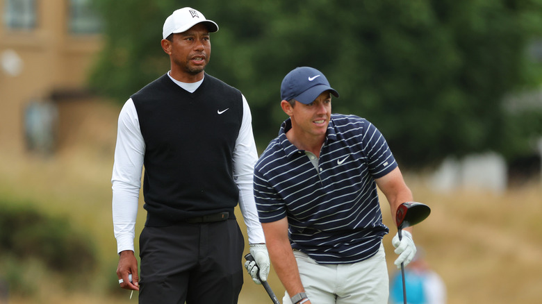 Rory McIlroy and Tiger Woods wearing hats