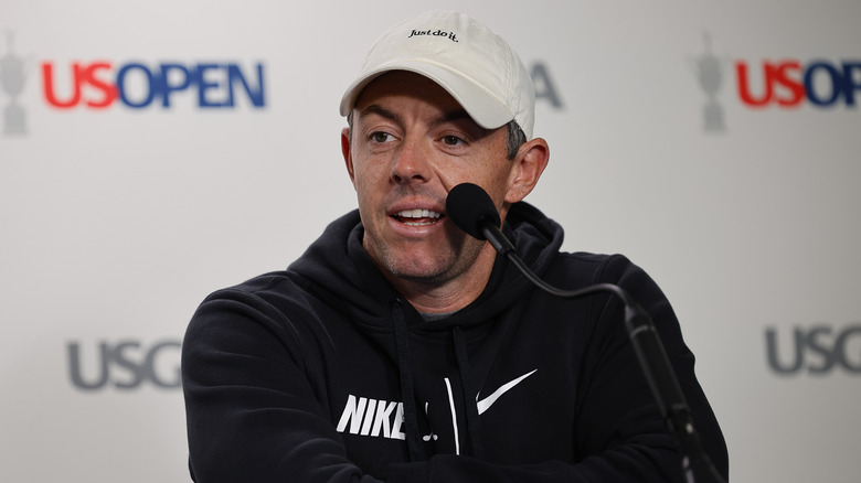 Rory McIlroy behind a microphone