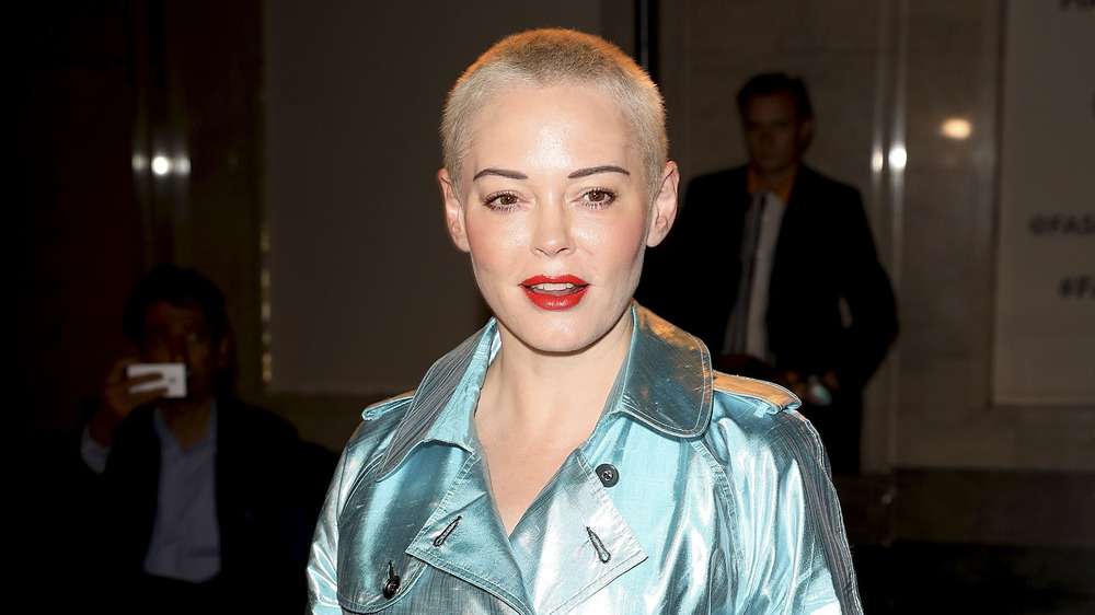 Rose McGowan wears red lipstick and a blue jacket