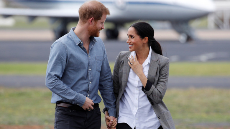 Prince Harry and Meghan Markle hold hands