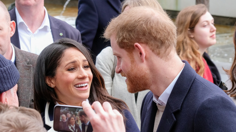 Prince Harry's thinning hair seen as he talks to Meghan