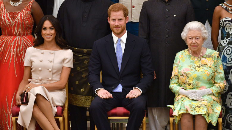 Meghan Markle with Prince Harry and Queen Elizabeth