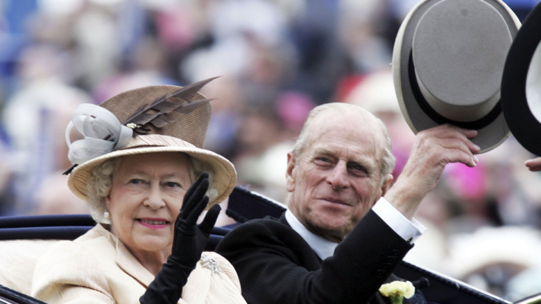 Queen Elizabeth and Prince Philip riding in a car