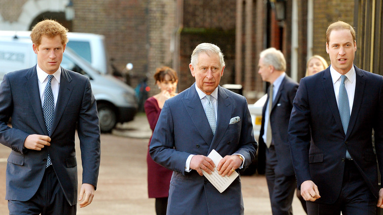 Prince Harry, Prince Charles, and Prince William walking