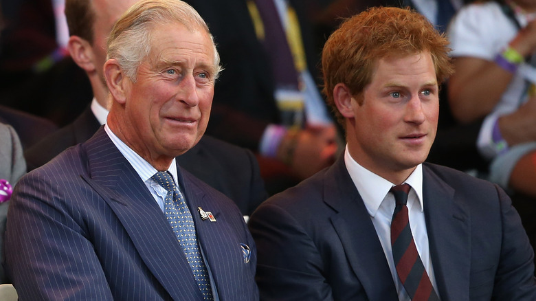 King Charles and Prince Harry seated during an outing