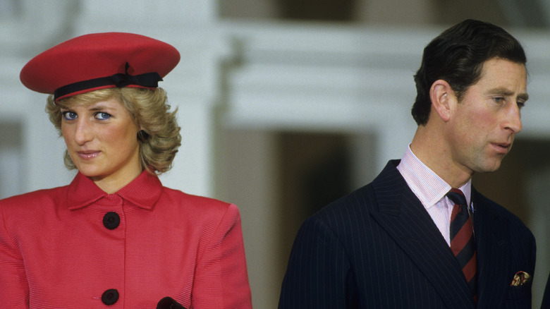 Princess Diana posing and Prince Charles looking away