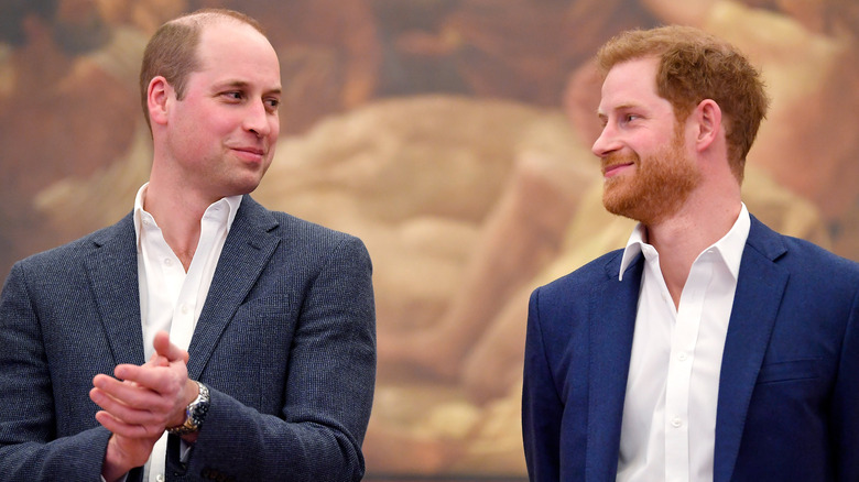 Prince William and Prince Harry smiling at each other