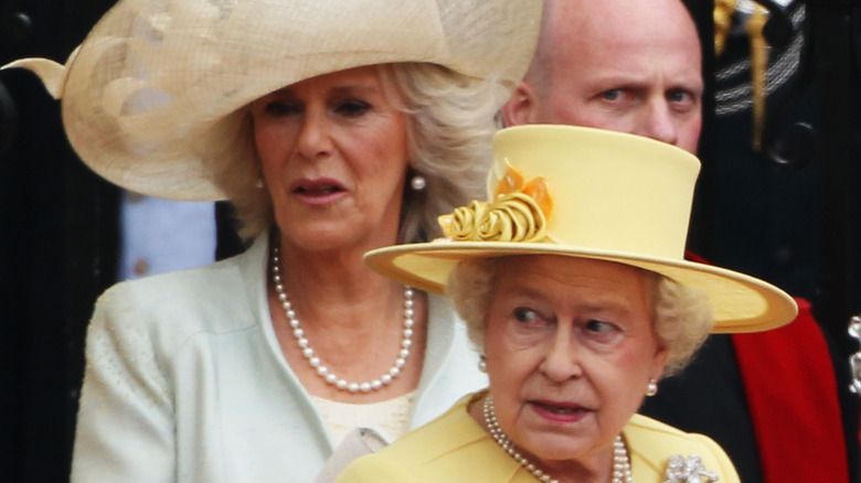 Queen Elizabeth II and Camilla looking away