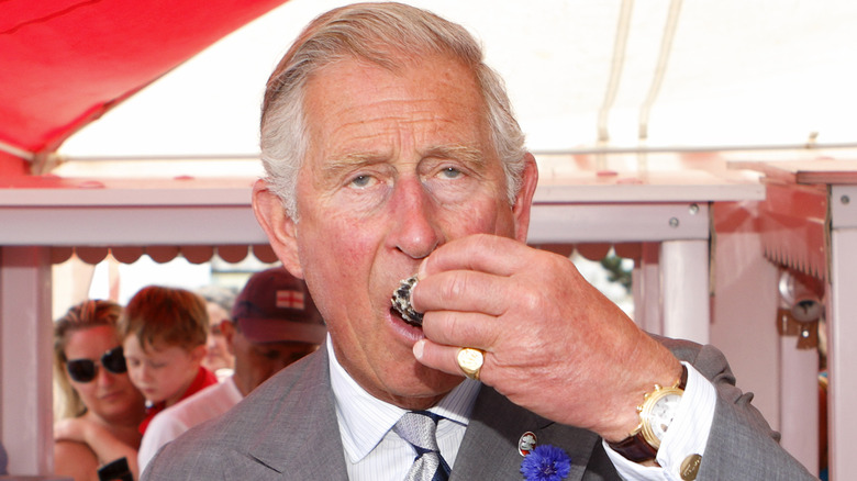 Prince Charles eating an oyster