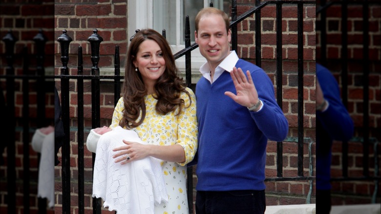 Kate Middleton holding baby Charlotte and Prince William waving