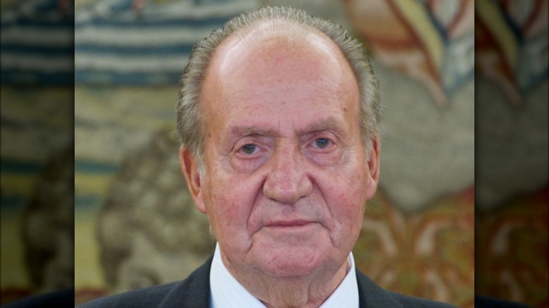 Juan Carlos I against tapestry background