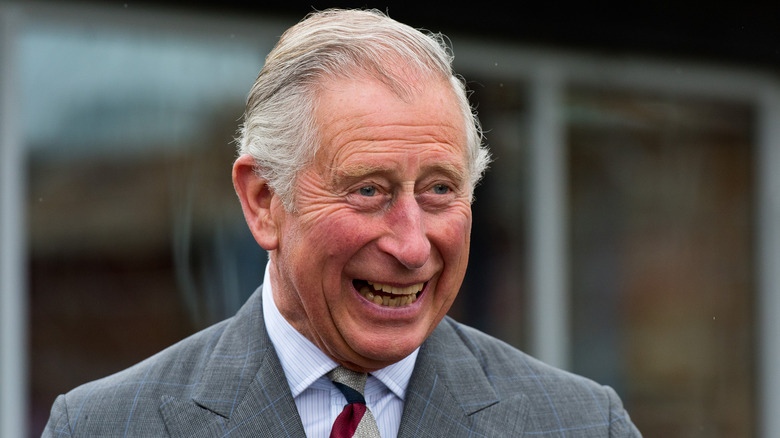 King Charles laughing to reveal rotten teeth