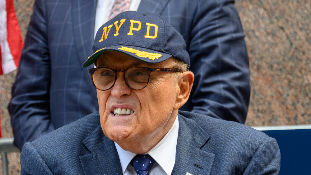 Rudy Giuliani wearing an NYPD hat