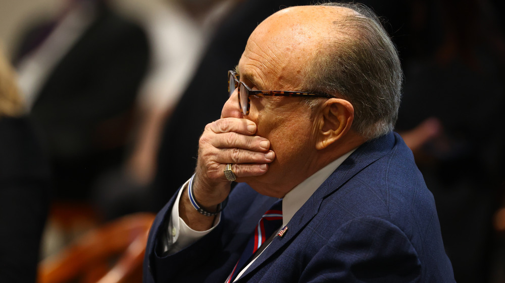 Rudy Giuliani covering his mouth