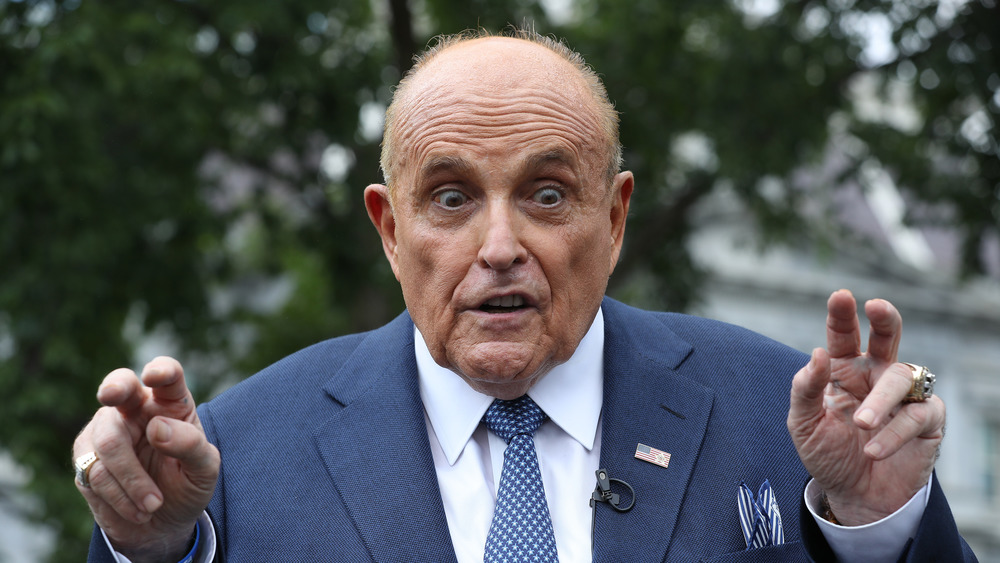 A wild-eyed Rudy Giuliani making air quotes 