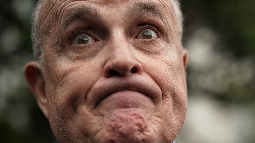 Rudy Giuliani raising his eyebrows and frowning 