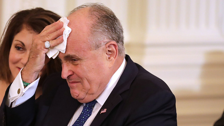 Rudy Giuliani mopping his brow