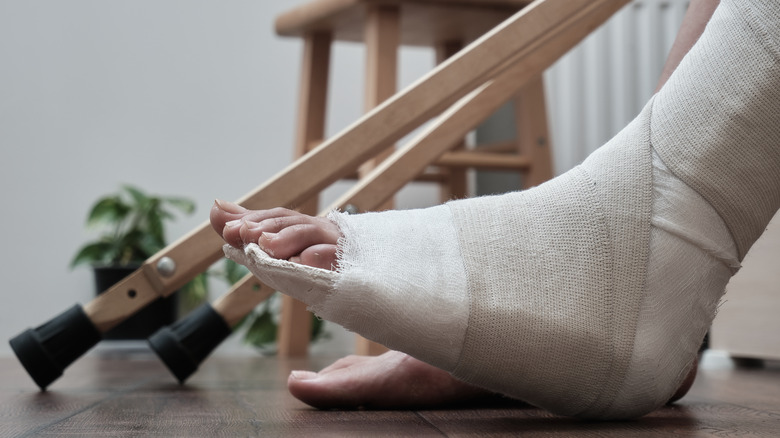 A foot wrapped in a bandage with crutches