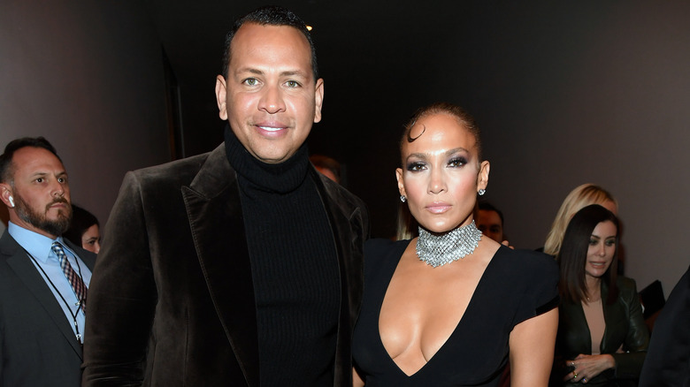 Alex Rodriguez smiling, Jennifer Lopez with stern expression