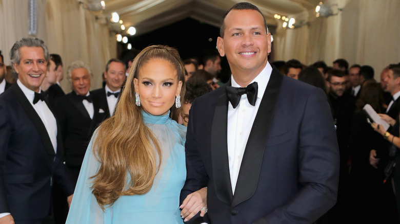 Jennifer Lopez linking arms with Alex Rodriguez